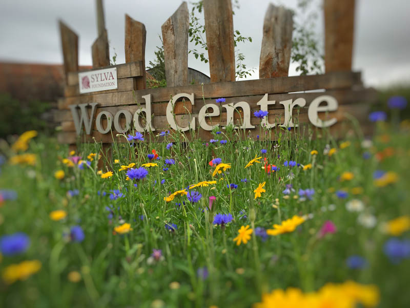 Sylva Wood Centre sign with flowers